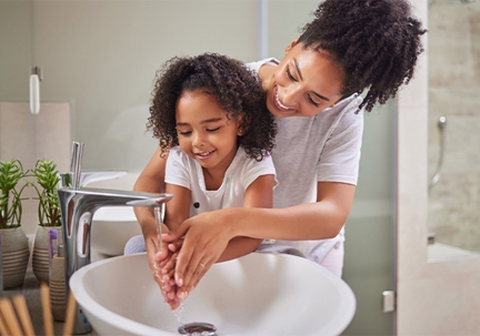 Mother and child using sink